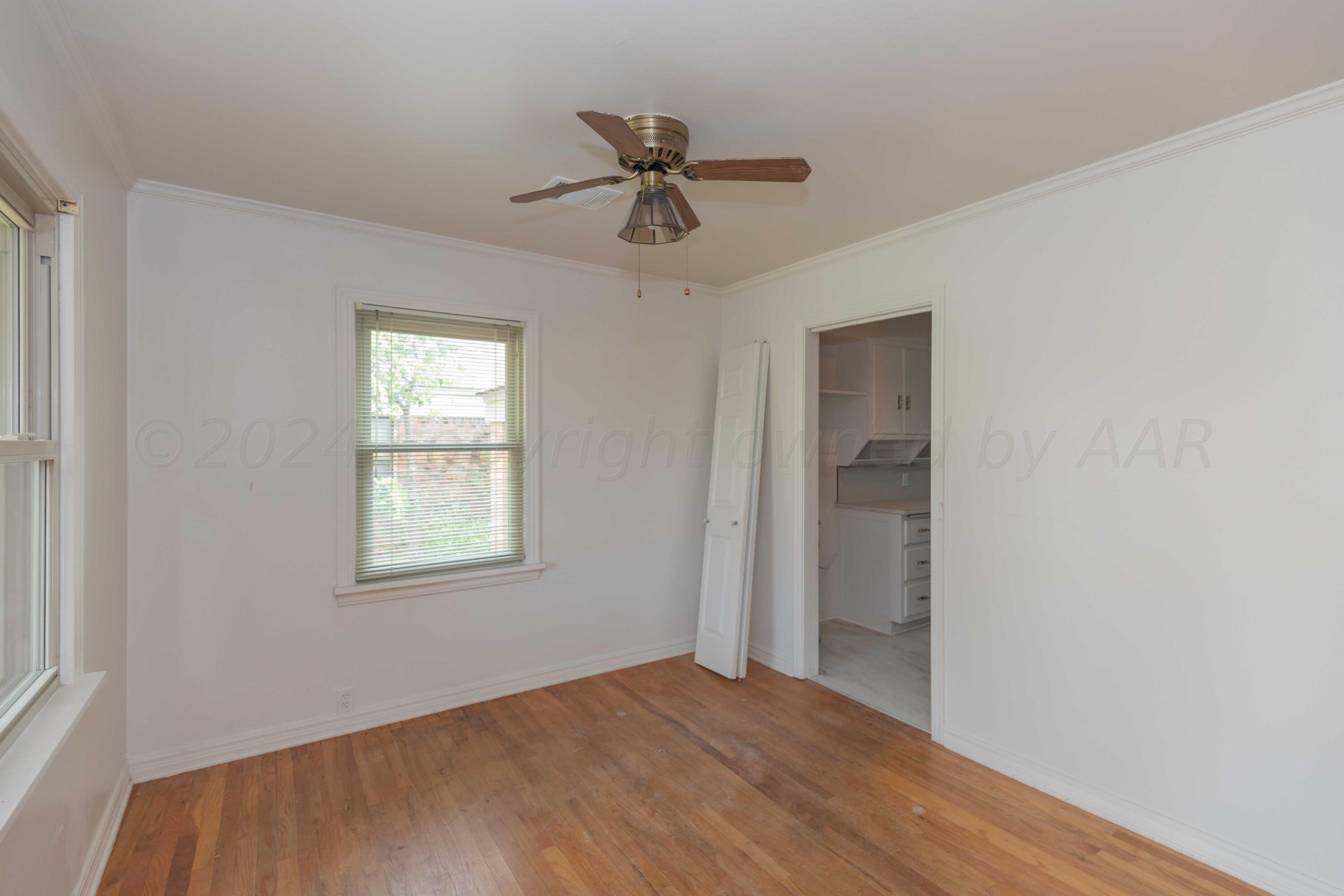 1613 South Travis Street Amarillo, TX 79102 - Photo 10 of 49 a view of an empty room with a window