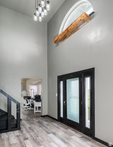 19994 South Olson Road Downey, ID 83234 - Photo 4 of 49 Entrance foyer featuring light wood-style flooring and a high ceiling