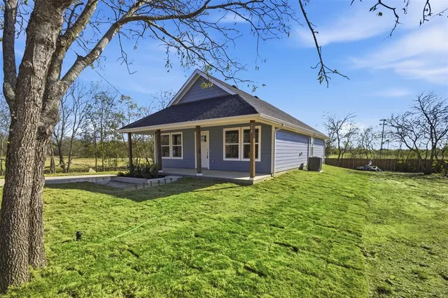 a view of a house with backyard porch and sitting area