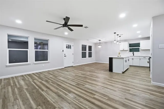 a view of kitchen with sink microwave and cabinets