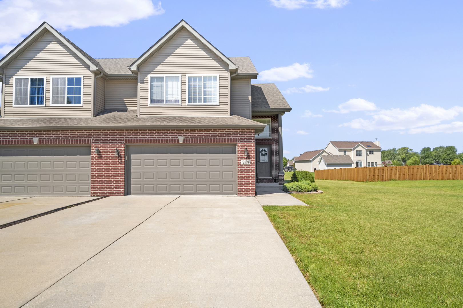 284 South Will Road Diamond, IL 60416 - Photo 2 of 23 a front view of a house with a yard and garage