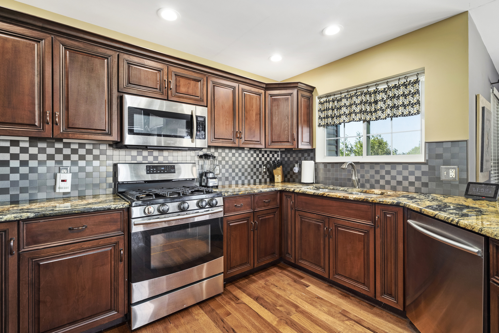 284 South Will Road Diamond, IL 60416 - Photo 11 of 23 a kitchen with stainless steel appliances granite countertop wooden cabinets stove top oven and sink