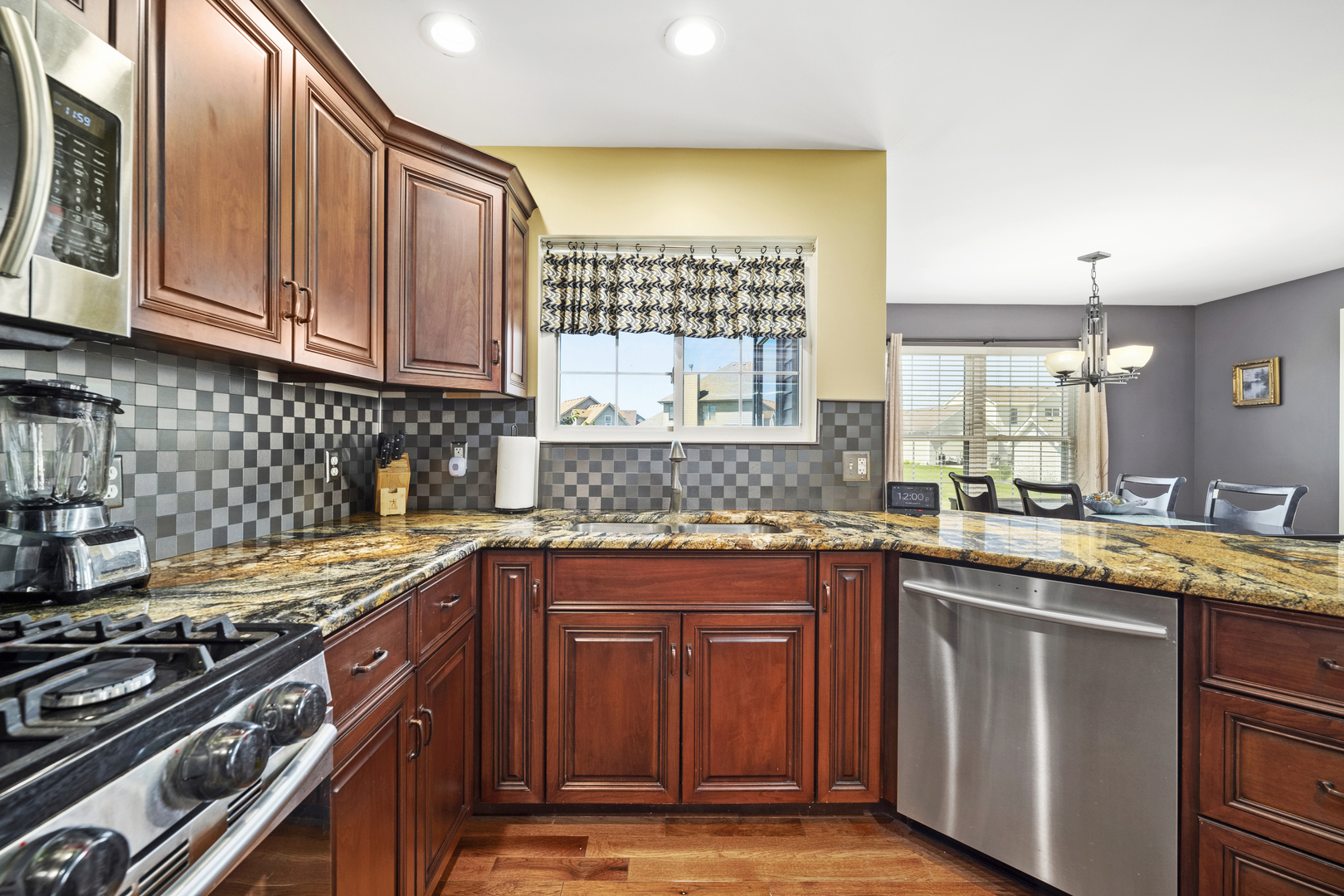 284 South Will Road Diamond, IL 60416 - Photo 12 of 23 a kitchen with stainless steel appliances granite countertop a stove a sink and a microwave