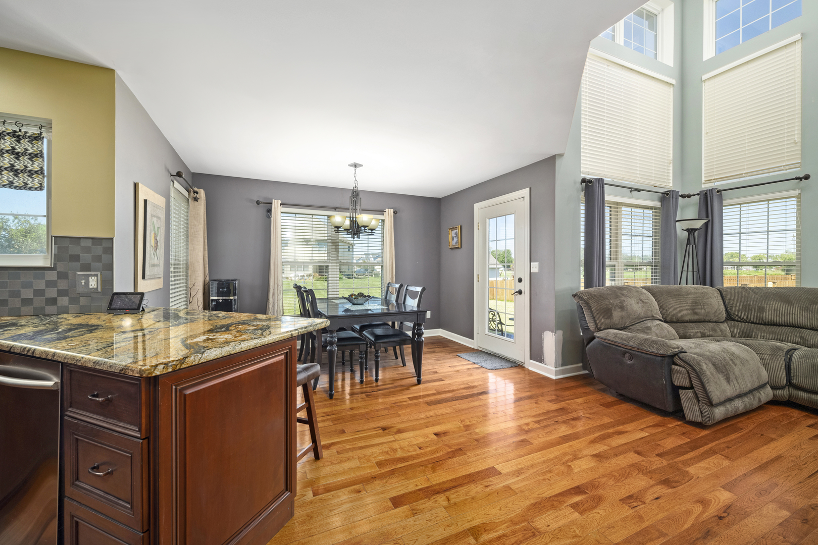 284 South Will Road Diamond, IL 60416 - Photo 8 of 23 a living room with furniture a dining table and a large window