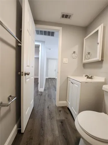 a white toilet sitting next to a bathroom sink