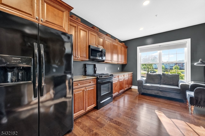 119 River Road Somerville, NJ 08876 - Photo 12 of 30 a kitchen with stainless steel appliances granite countertop a refrigerator a stove and a sink with wooden floor