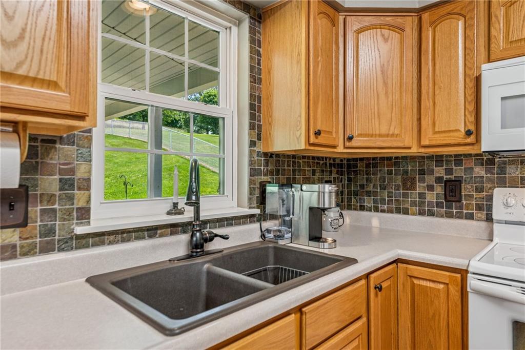 142 Poorbaugh Road Connellsville, PA 15425 - Photo 12 of 41 a kitchen with granite countertop a sink and a window