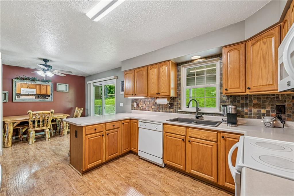 142 Poorbaugh Road Connellsville, PA 15425 - Photo 10 of 41 a kitchen with a sink stove and cabinets