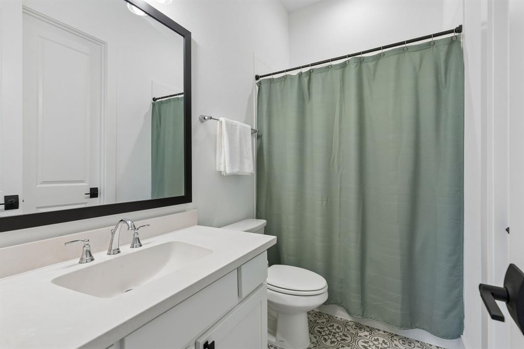 566 Broadleaf Way Haslet, TX 76052 - Photo 31 of 38 Bathroom featuring a spacious vanity with integrated sink, chrome faucet fixtures, and a large framed mirror