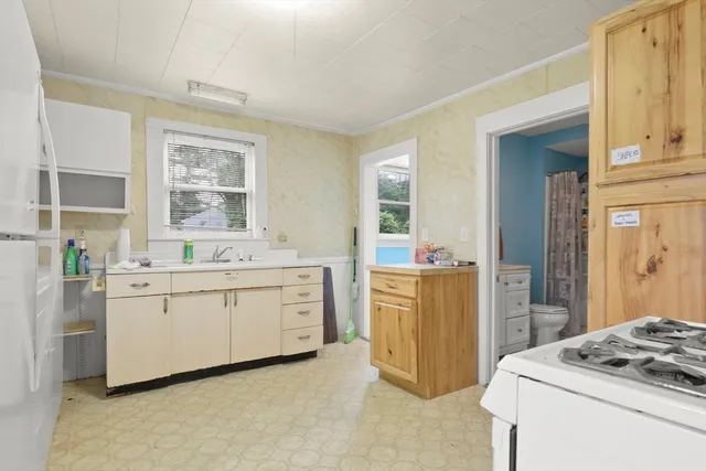 a kitchen with white cabinets and white appliances