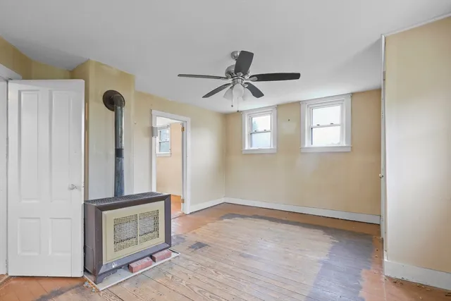 a view of a hallway with a fireplace and a window
