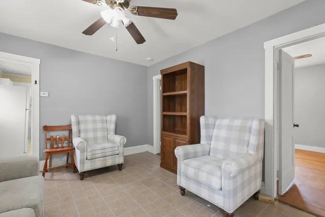 a living room with furniture and a ceiling fan