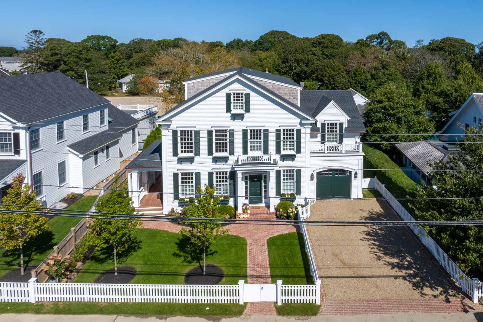 183 Upper Main Street Edgartown, MA 02539 - Photo 31 of 33 a view of a white house with a yard and potted plants