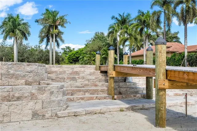 a palm tree sitting in front of a building with palm trees