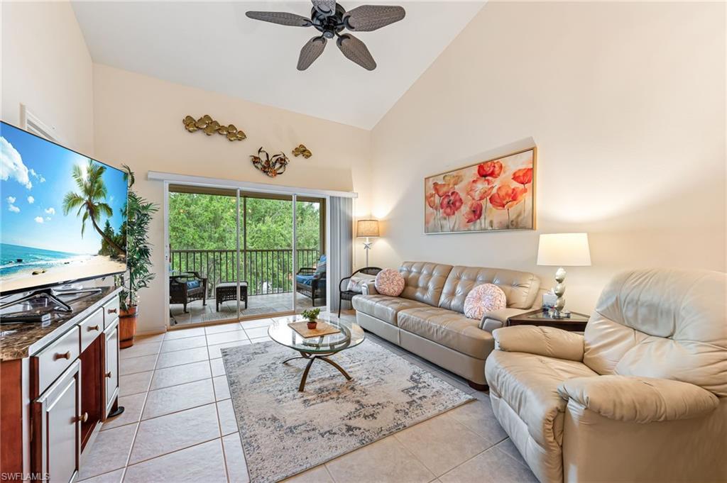 9185 Celeste Drive, Unit 305 Naples, FL 34113 - Photo 1 of 35 a living room with furniture and a flat screen tv