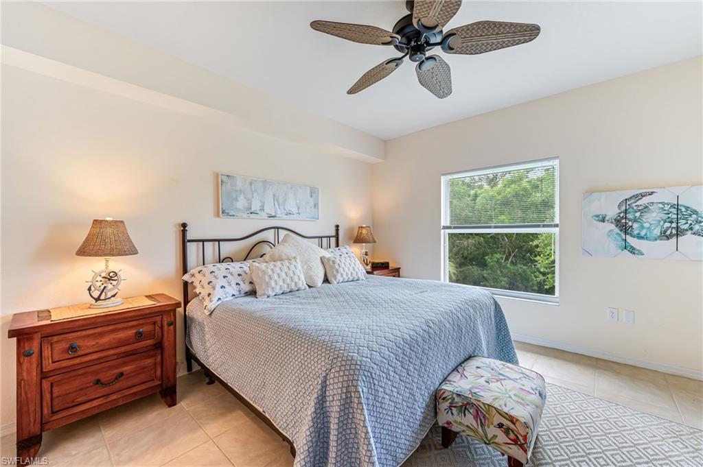 9185 Celeste Drive, Unit 305 Naples, FL 34113 - Photo 13 of 35 a bedroom with a bed and a window