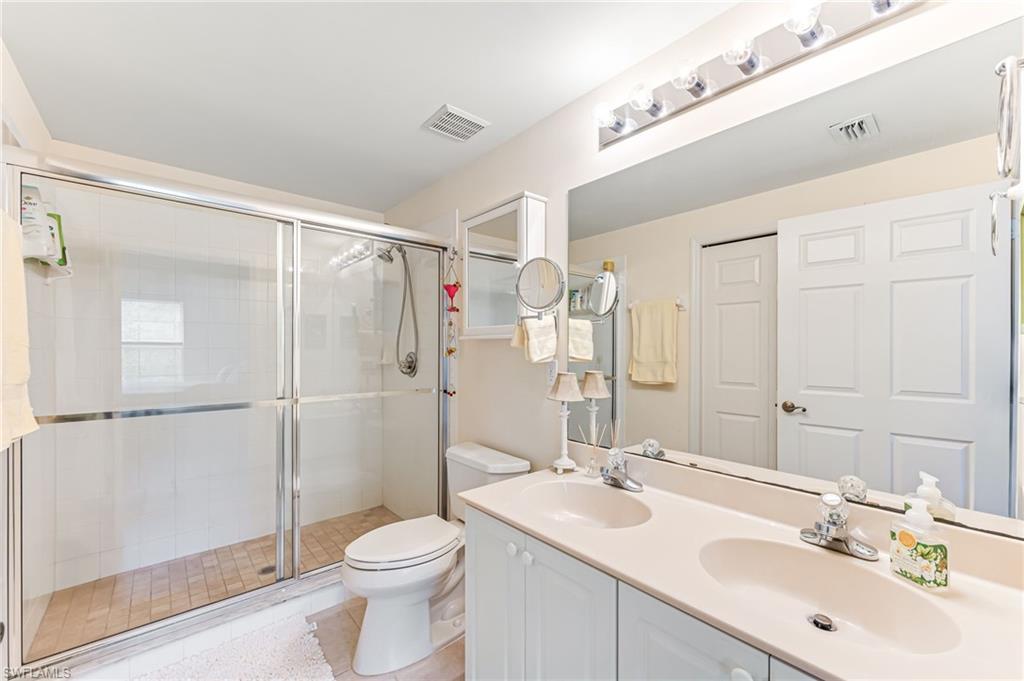 9185 Celeste Drive, Unit 305 Naples, FL 34113 - Photo 16 of 35 a bathroom with a sink toilet and shower