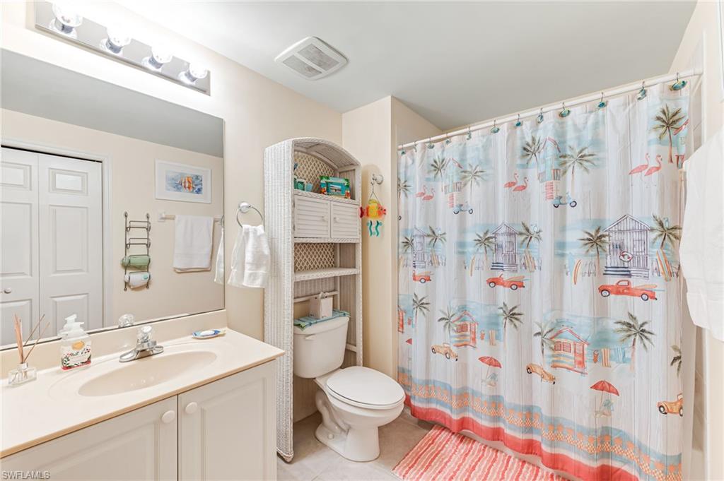 9185 Celeste Drive, Unit 305 Naples, FL 34113 - Photo 19 of 35 a bathroom with a sink toilet and shower