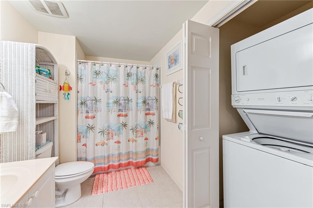 9185 Celeste Drive, Unit 305 Naples, FL 34113 - Photo 20 of 35 a white toilet sitting next to a bathroom sink
