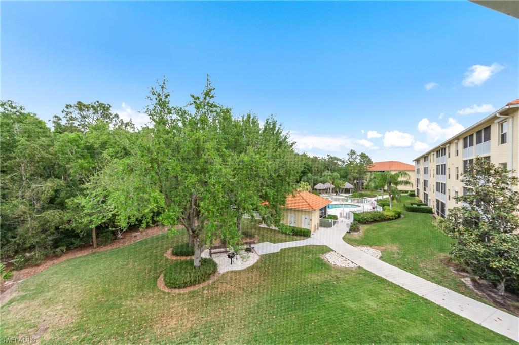 9185 Celeste Drive, Unit 305 Naples, FL 34113 - Photo 24 of 35 a view of a backyard with sitting area