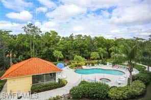 9185 Celeste Drive, Unit 305 Naples, FL 34113 - Photo 25 of 35 a view of a house with a yard and potted plants