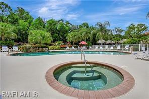9185 Celeste Drive, Unit 305 Naples, FL 34113 - Photo 26 of 35 a view of a swimming pool with a yard