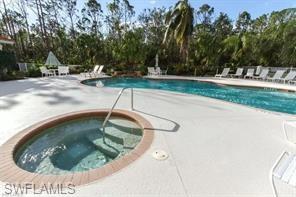 9185 Celeste Drive, Unit 305 Naples, FL 34113 - Photo 30 of 35 a view of a swimming pool with a sitting space