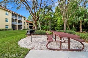 9185 Celeste Drive, Unit 305 Naples, FL 34113 - Photo 32 of 35 a view of a backyard with a garden and plants