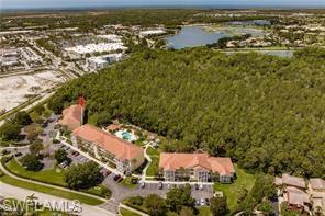 9185 Celeste Drive, Unit 305 Naples, FL 34113 - Photo 34 of 35 an aerial view of residential houses with outdoor space