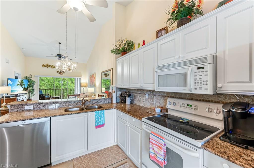 9185 Celeste Drive, Unit 305 Naples, FL 34113 - Photo 9 of 35 a kitchen with a stove a sink and cabinets