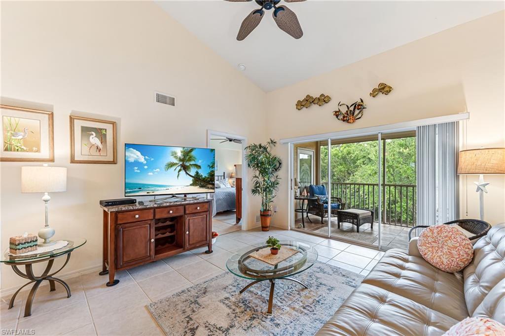 9185 Celeste Drive, Unit 305 Naples, FL 34113 - Photo 10 of 35 a living room with furniture and a large window