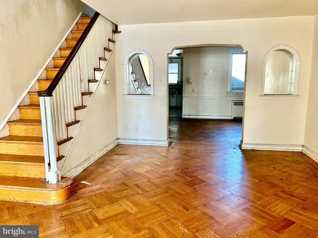 a view of entryway with wooden floor and stairs