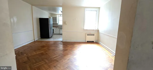 a view of a kitchen with refrigerator and window