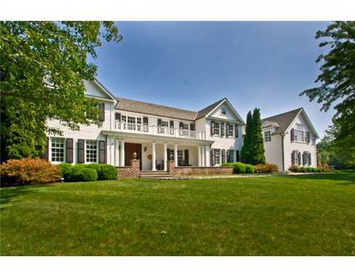 30 Pear Tree Point Road Darien, CT 06820 - Photo 1 of 20 a front view of a house with a garden