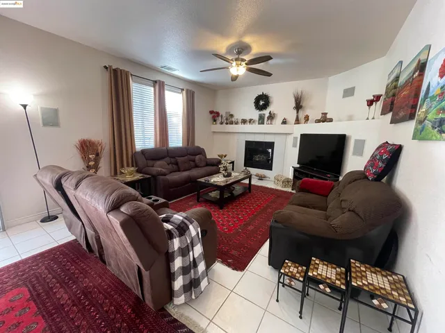 a living room with furniture fireplace and a window