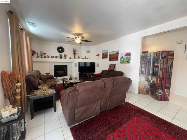 a living room with furniture fireplace and flat screen tv