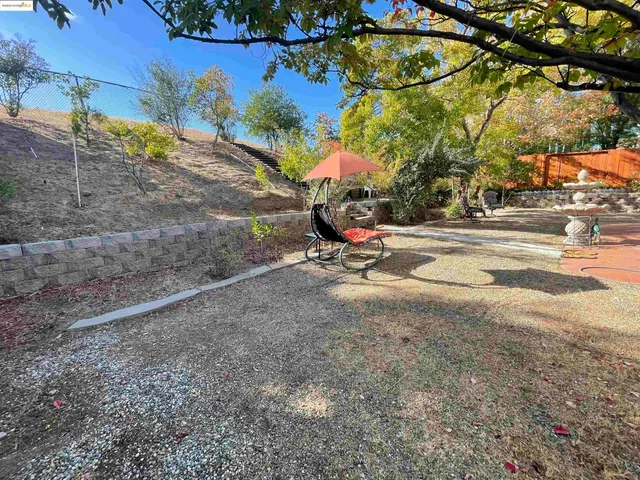 a view of a park with iron fence