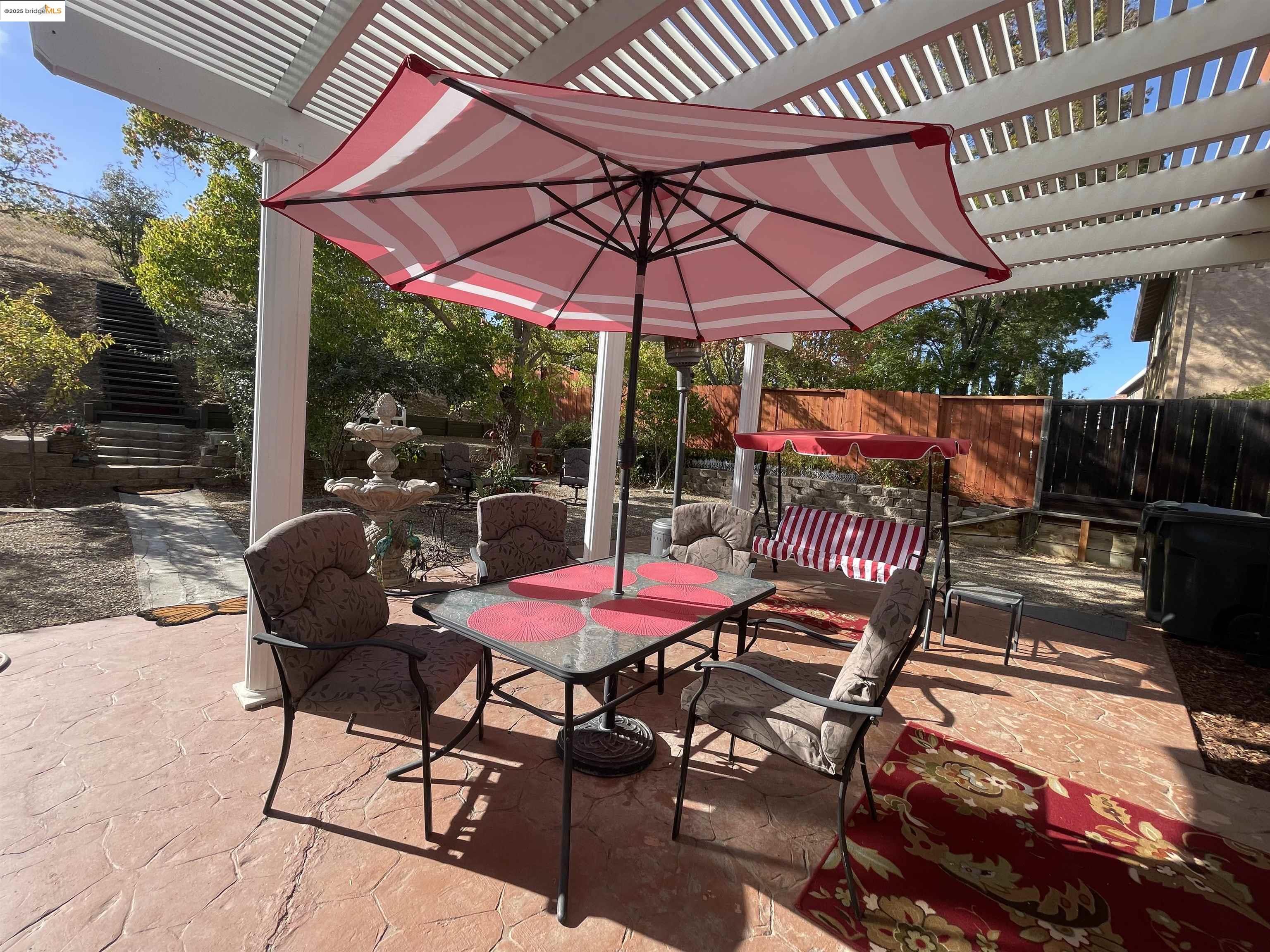 1928 Badger Pass Way Antioch, CA 94531 - Photo 32 of 50 a patio with tables and chairs and a umbrella