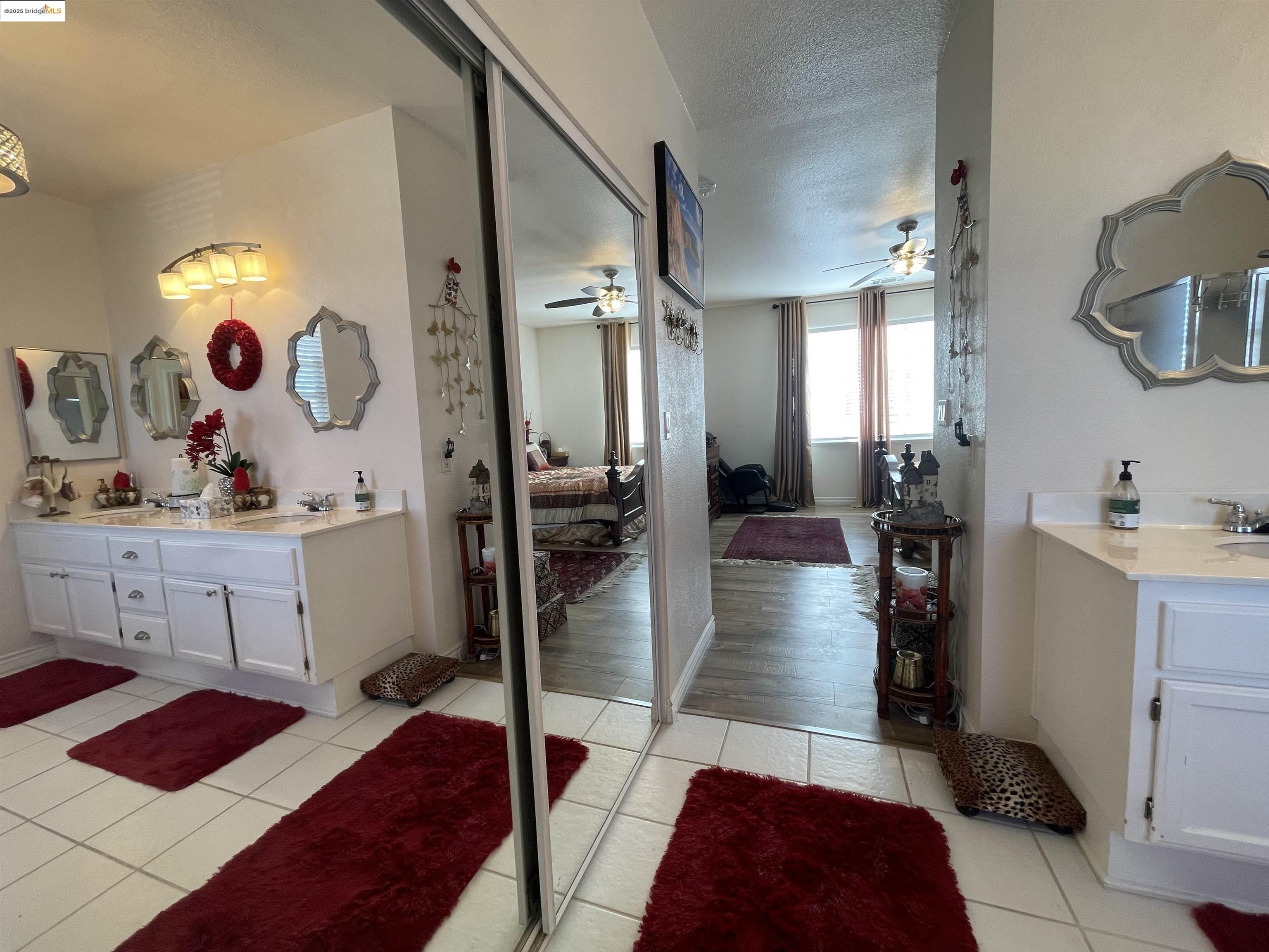 1928 Badger Pass Way Antioch, CA 94531 - Photo 41 of 50 a hallway with white cabinets and couches with wooden floor