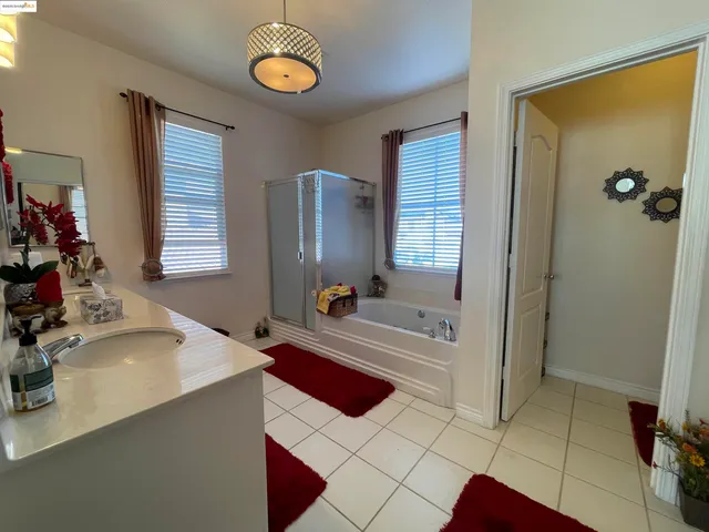 a hallway with white cabinets and musical instruments