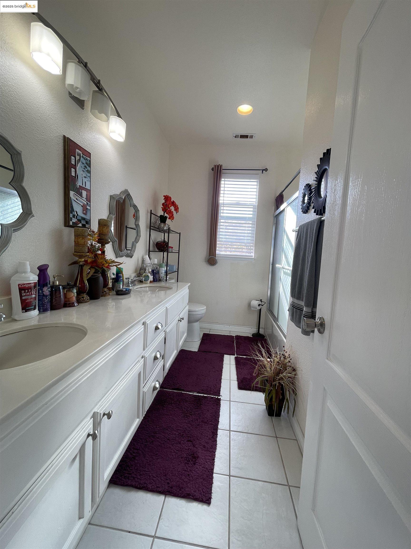 1928 Badger Pass Way Antioch, CA 94531 - Photo 44 of 50 a hallway with white cabinets and musical instruments