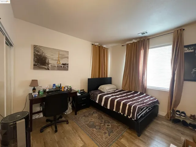 a bed room with a bed and dresser