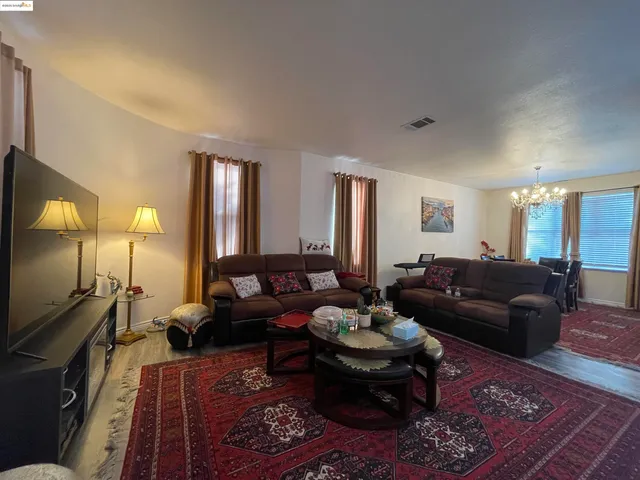 a living room with furniture couches and a flat screen tv