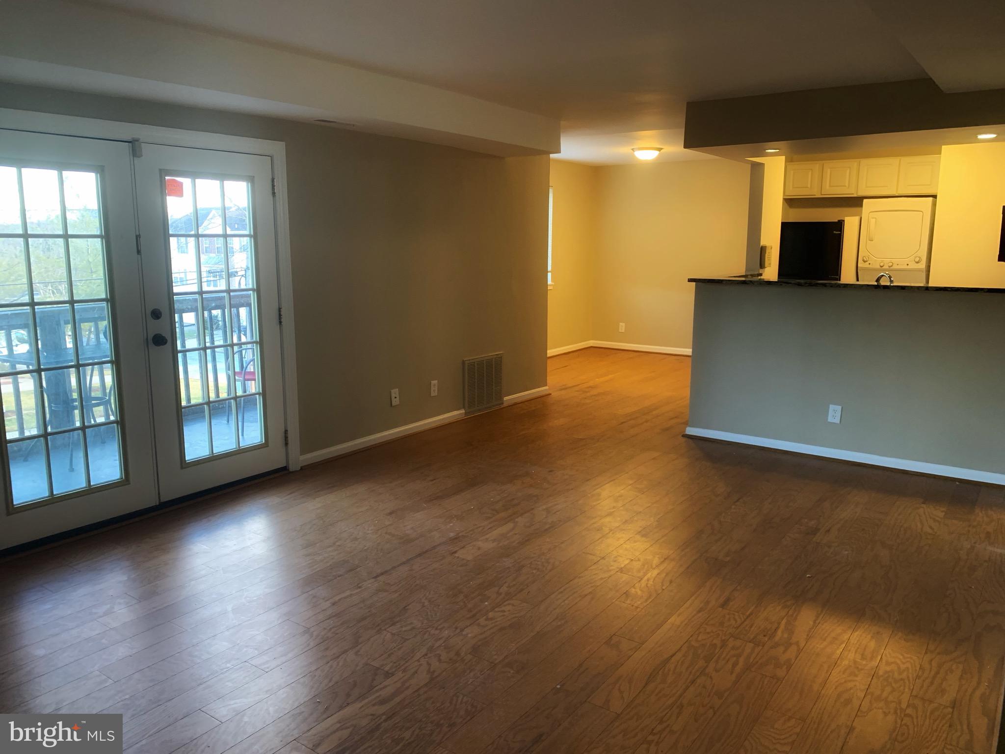 2500 Markham Lane, Unit 1 Landover, MD 20785 - Photo 3 of 4 an empty room with wooden floor and windows