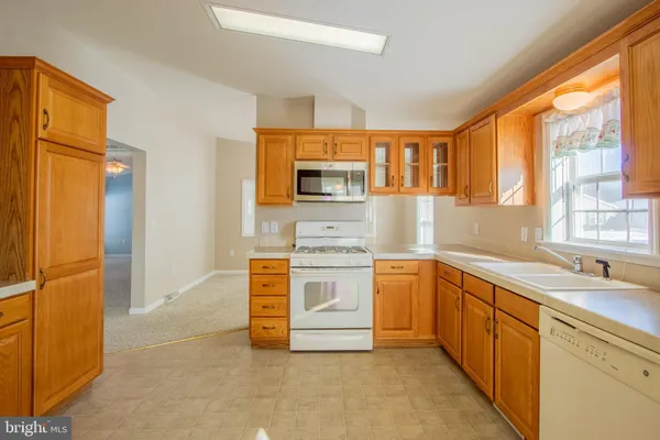 a kitchen with stainless steel appliances a stove sink and microwave