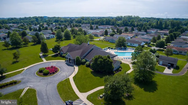 an aerial view of multiple houses with yard
