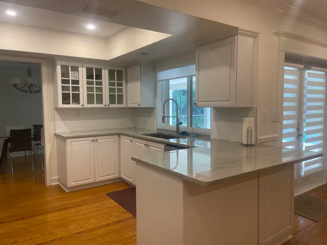a kitchen with stainless steel appliances granite countertop a sink stove and cabinets