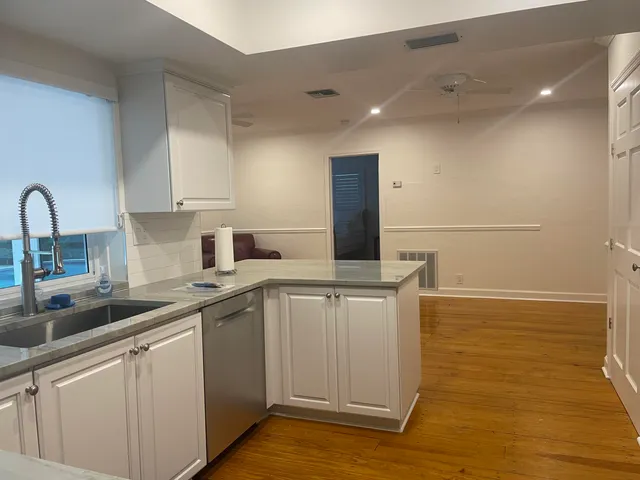 a kitchen with a sink cabinets and appliances