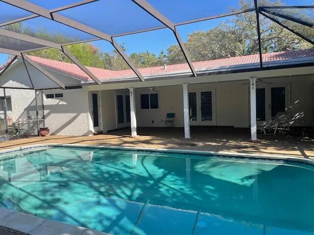 a view of a house with backyard porch and sitting area