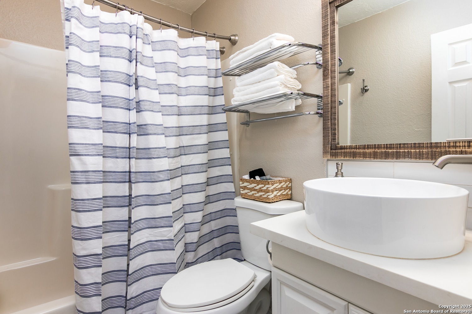 6804 River New Braunfels, TX 78132 - Photo 8 of 16 a bathroom with a sink a toilet and a mirror